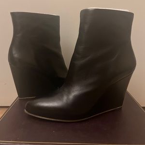 Vince Camuto black leather wedge booties with chain detail